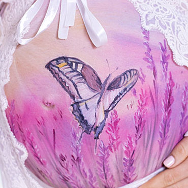 Bemalung auf Schwangerschaftsbauch mit einem Schmetterling im Lavendel